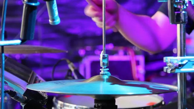 rock drummer playing the drums at the stage