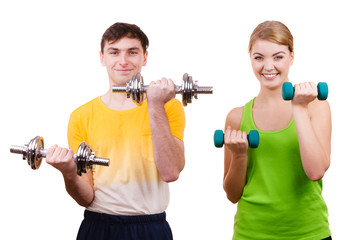Fototapeta na wymiar Couple exercising with dumbbells lifting weights