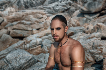 Tribal warrior. Young attractive man outdoor portrait.