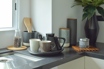 Ceramic ware on black counter top in the kitchen