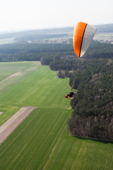aerial view of paramotor flying over the fields i