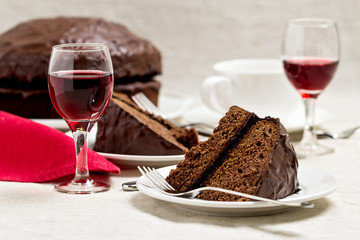 Chocolate cake and glasses of wine.