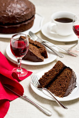 Chocolate cake and glasses of wine.