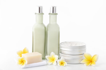 Obraz na płótnie Canvas Set of different cosmetic product with frangipani flowers