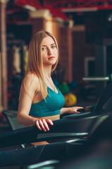 Shot of a girl running on the treadmill