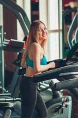 Fototapeta na wymiar Shot of a girl running on the treadmill