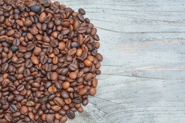 Coffee beans on wood background
