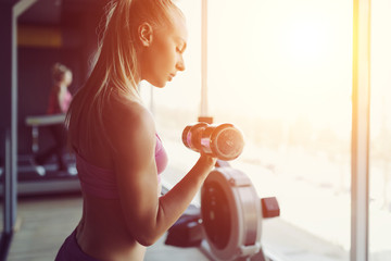 Strong and beautiful athletic woman training in the gym