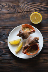 Seafood julienne served with lemon in a rustic wooden setting