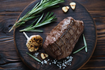 Close-up of grilled asado steak with condiments, high angle view