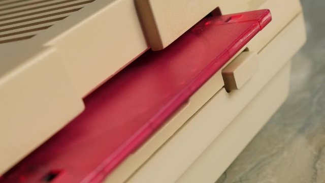 Pink ancient floppy disk inserting in personal computer 4K 3840X2160 UltraHD footage - Floppy disk insert into disk drive close-up 4K 2160p UHD video 