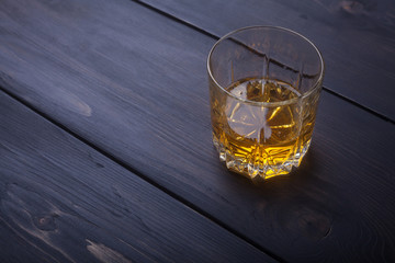 Whiskey on dark wood