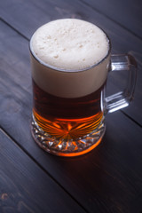 Mug of beer on wood