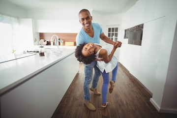 Happy couple dancing in the kitchen