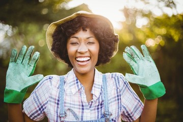 happy woman showing her gardening gloves