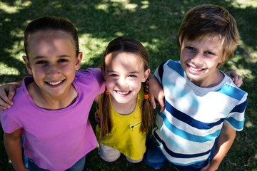 Portrait of happy children standing in park