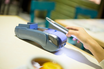 Woman using mobile phone to pay