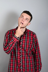 Fototapeta premium young handsome man doubting isolated over gray background