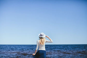 girl in the hat is back on the beach