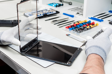 Close-up photos showing process of tablet device repair