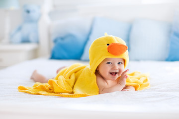 Cute baby after bath in yellow duck towel