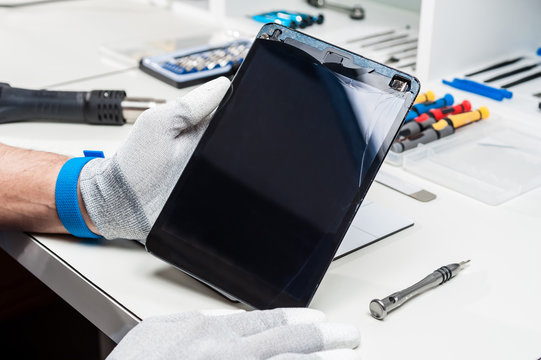 Close-up photos showing process of tablet device repair