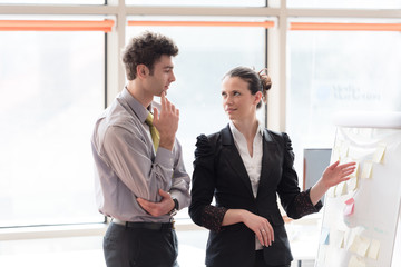young couple working on flip board at office