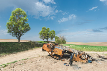 Abandoned rusty burnt car wreck, Car that has been burn right out, even the tyres are burnt up.