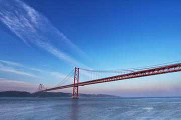 Fototapeta na wymiar Red bridge at sunset, Lisbon, Portugal. Travel background