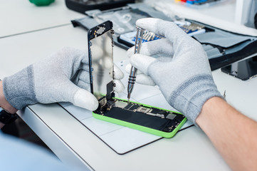 Close-up photos showing process of mobile phone repair
