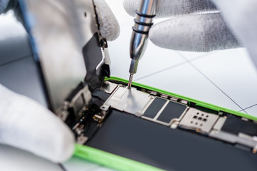 Close-up photos showing process of mobile phone repair
