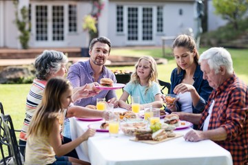 Happy family having lunch in the garden