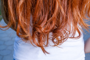 Rear view of red haired woman and copyspace on shirt beneath