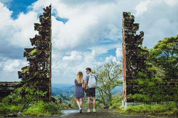 Hipster couple against the backdrop of ancient Hindu gate and mo