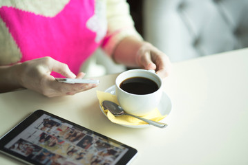 Female hand on the table, technology, internet, woman drinking coffee