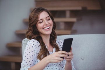 Beautiful woman looking at her mobile phone