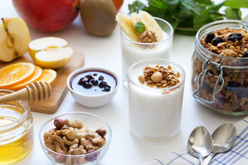 Healthy breakfast with yogurt in glass, granola and fruits