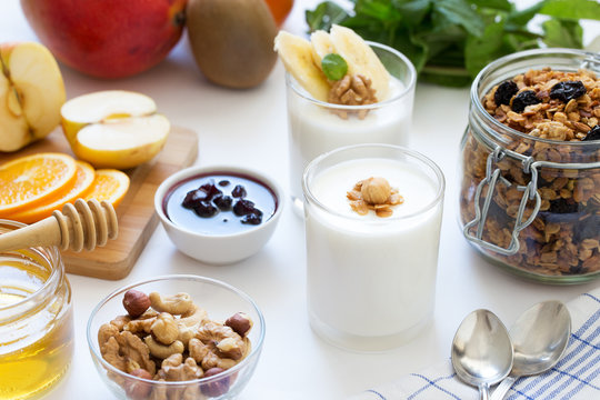 Healthy breakfast with yogurt in glass, granola and fruits