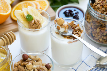 Healthy breakfast with yogurt in glass, granola and fruits