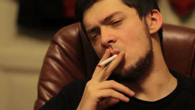 Man smoking in a chair
