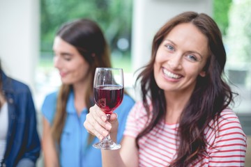 Beautiful woman holding a glass of red wine