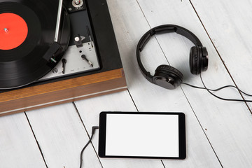 Vintage turntable, phablet and headphones