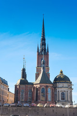 Obraz premium Stockholm, Sweden - March, 16, 2016: cars on a parking near cathedral in Stockholm, Sweden