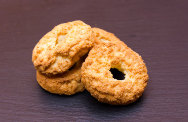 Some cookies on a slate floor seen up close