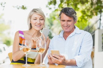 Happy couple using mobile phone
