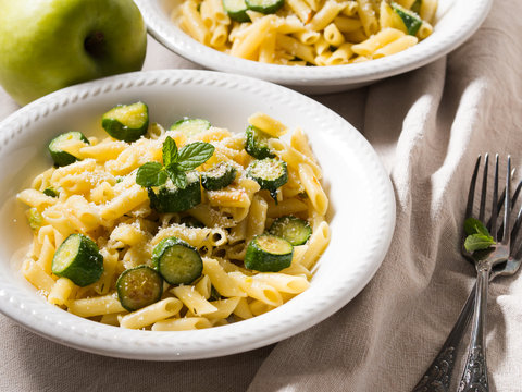 Pennette pasta with zucchini, mint leaves and parmesan