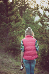 Woman posing outdoor. Hiker  enjoying view in forest during hiking trip.