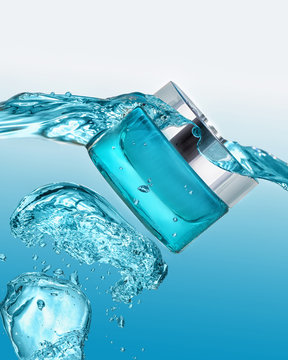The blue  jar of moisturizing gel with blue water splash around the jar on the gradient blue background