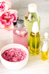 Spa setting with pink roses and aroma oil, vintage style 