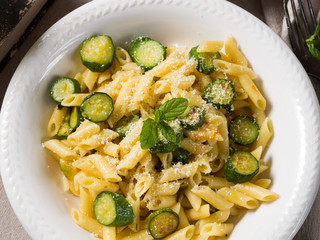 Pennette pasta with zucchini, mint leaves and parmesan